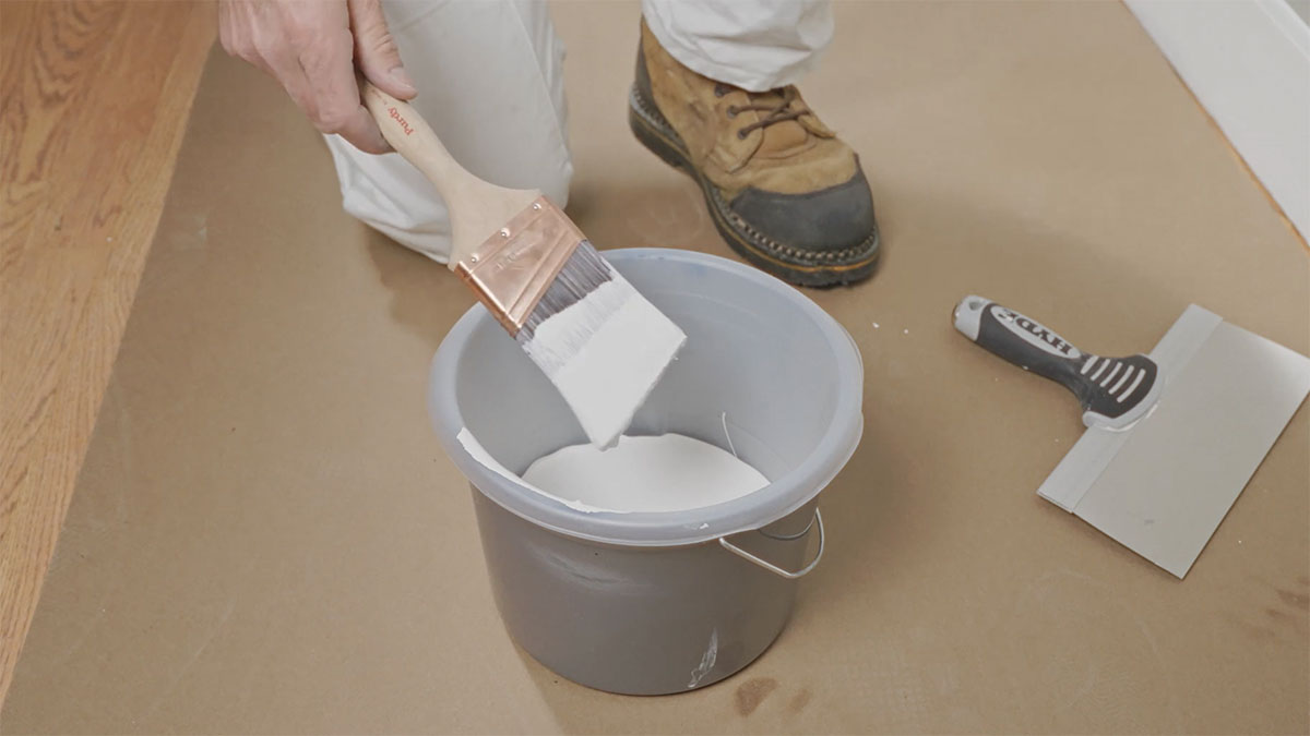 Loading an angled paintbrush with white paint